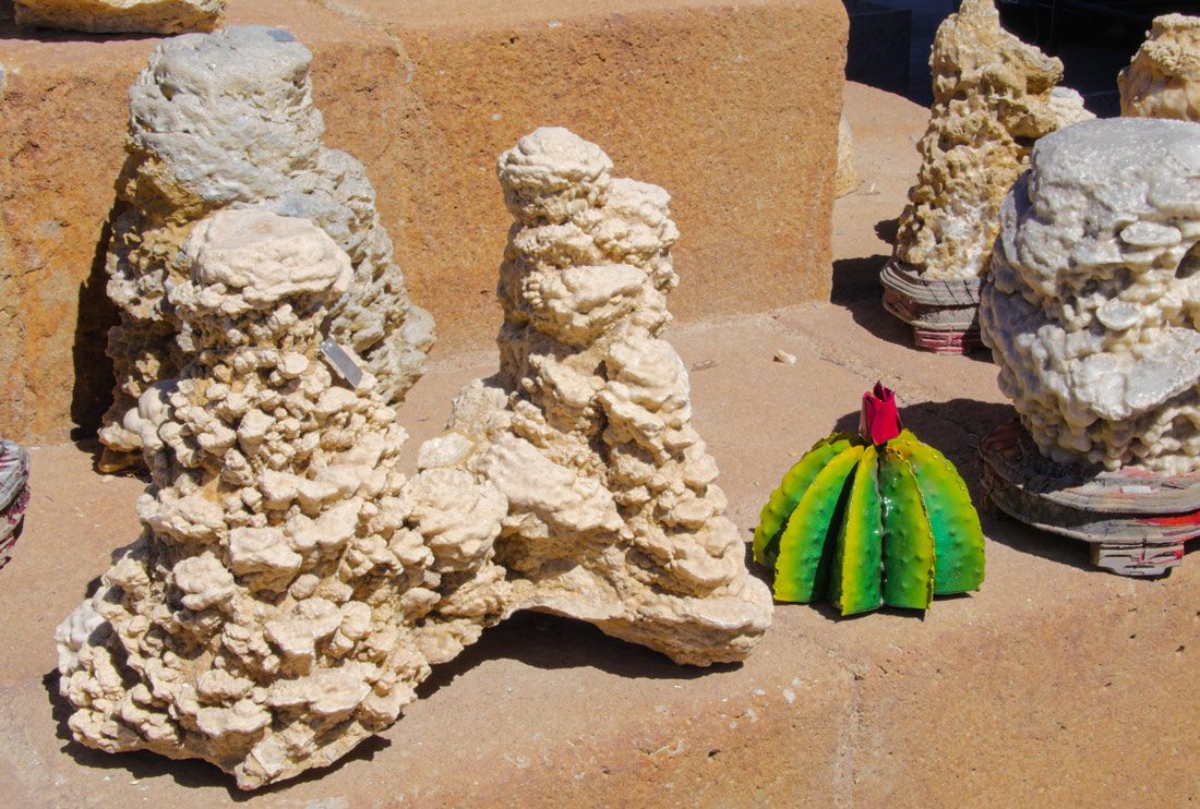 Natural rock textures with green cactus nearby