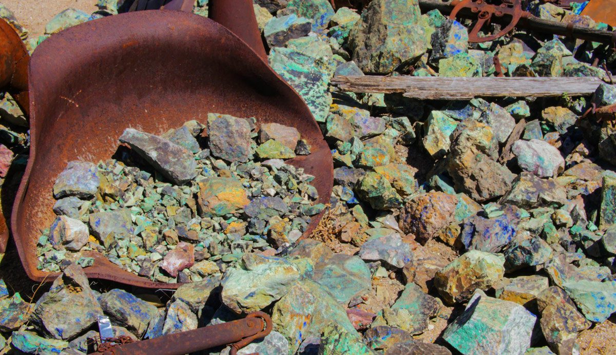 Rusty wheelbarrow with colorful rocks