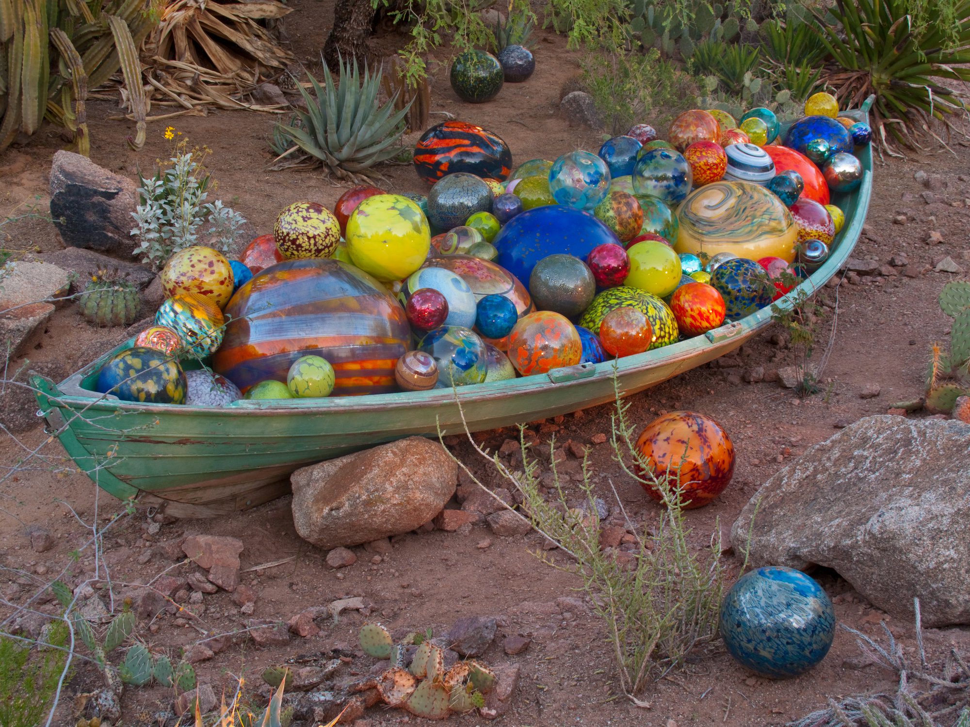 Colorful glass spheres in a wooden boat.