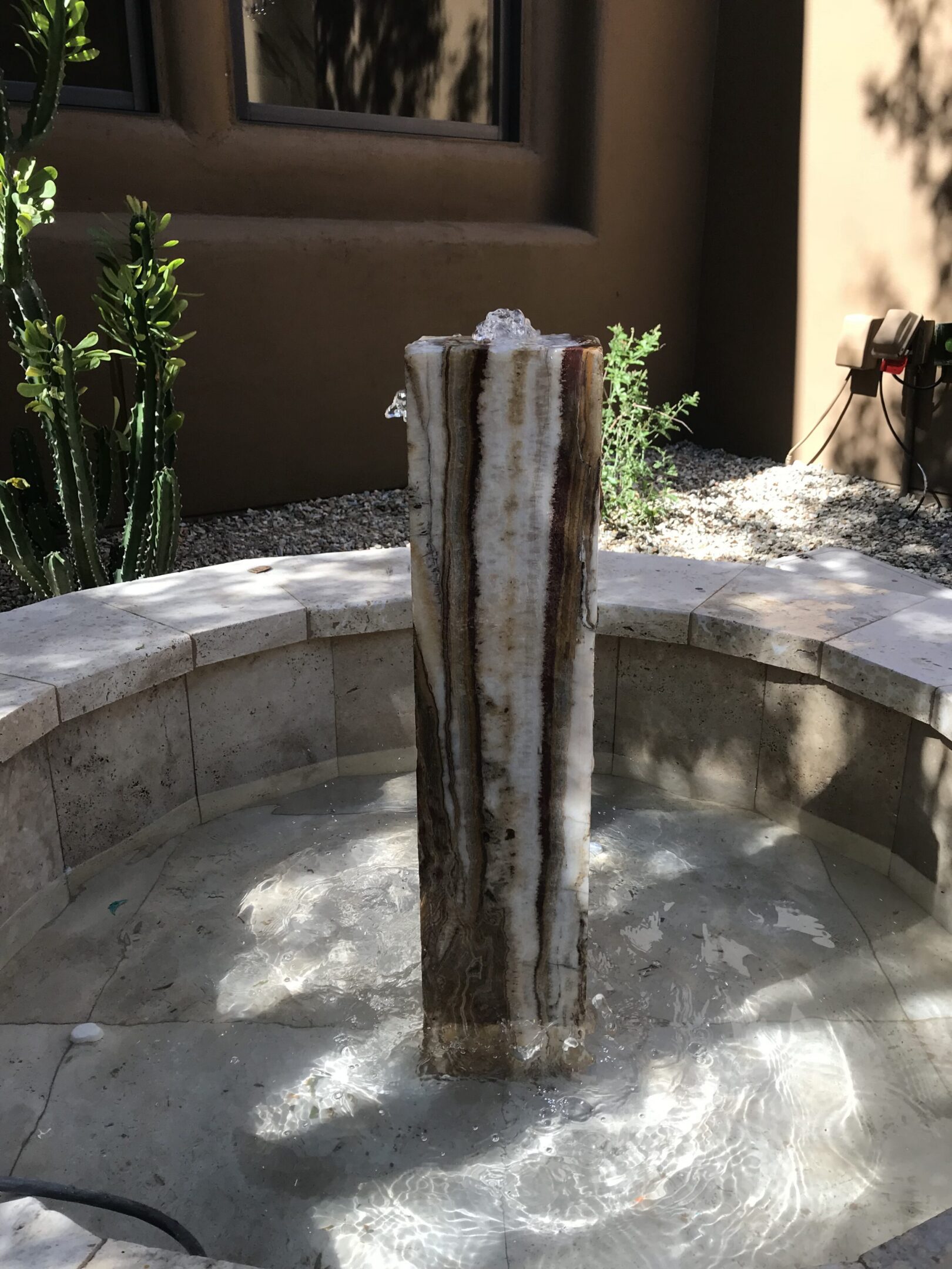 quarried stone fountain installed in a customer's fountain basin